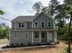 Charming two-story home featuring a welcoming front porch, gray siding, and large windows at 509 Olive Branch Rd, Durham, NC 27703