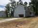 View of home featuring an attached two-car garage, gray siding, and neatly landscaped yard at 509 Olive Branch Rd, Durham, NC 27703