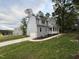 Charming two-story home with gray siding, a front porch, and a paved driveway at 509 Olive Branch Rd, Durham, NC 27703