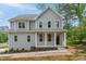 Charming two-story home with a welcoming front porch and gray siding at 509 Olive Branch Rd, Durham, NC 27703