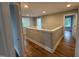 Bright hallway featuring hardwood floors, natural light, and neutral paint at 509 Olive Branch Rd, Durham, NC 27703