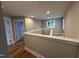 Hallway featuring hardwood floors, natural light, and neutral paint at 509 Olive Branch Rd, Durham, NC 27703