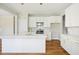 Stylish kitchen features white cabinets, an island, and gold hardware at 509 Olive Branch Rd, Durham, NC 27703
