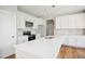 Modern kitchen with an island, quartz countertops, and a tile backsplash at 509 Olive Branch Rd, Durham, NC 27703