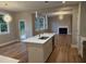 Bright kitchen with white island, stainless steel appliances, and modern lighting fixtures at 509 Olive Branch Rd, Durham, NC 27703