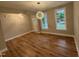 Bright living room with large windows, hardwood flooring, and modern lighting, creating a welcoming atmosphere at 509 Olive Branch Rd, Durham, NC 27703