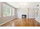 Bright living room with a fireplace, wood floors, and large windows at 509 Olive Branch Rd, Durham, NC 27703
