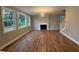 Spacious living room with hardwood floors, fireplace, and three large windows at 509 Olive Branch Rd, Durham, NC 27703
