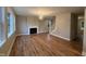 Open-concept living room with a fireplace, hardwood floors, and lots of natural light at 509 Olive Branch Rd, Durham, NC 27703