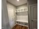 Mudroom with bench seating, cubbies, and wood-look flooring at 509 Olive Branch Rd, Durham, NC 27703