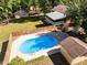 Aerial perspective highlighting a fenced backyard with a refreshing pool and charming outbuildings, perfect for outdoor enjoyment at 525 Turtle Creek Farm Rd, Apex, NC 27523