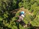 Aerial view of a home featuring a backyard pool, bordered by lush trees and offering privacy at 525 Turtle Creek Farm Rd, Apex, NC 27523