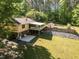 Spacious backyard with lush lawn, patio, covered deck, fence and storage shed perfect for outdoor entertaining at 525 Turtle Creek Farm Rd, Apex, NC 27523