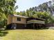 Backyard view of the house showcasing a large deck, brick foundation, and spacious grassy area at 525 Turtle Creek Farm Rd, Apex, NC 27523