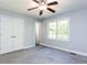 This bedroom has carpet floors, a ceiling fan, a window, and neutral walls at 525 Turtle Creek Farm Rd, Apex, NC 27523