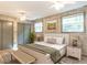 Bright bedroom features a ceiling fan, bed, two windows, and unique wallpaper at 525 Turtle Creek Farm Rd, Apex, NC 27523