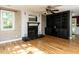 Cozy living room features a fireplace, hardwood floors, and built-in shelving for storage and decor at 525 Turtle Creek Farm Rd, Apex, NC 27523