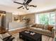 Comfortable living room featuring a large window, ceiling fan, and stylish decor at 525 Turtle Creek Farm Rd, Apex, NC 27523