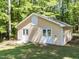 Detached outbuilding with double doors, offering versatile space for a workshop or storage at 525 Turtle Creek Farm Rd, Apex, NC 27523