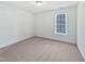 Cozy bedroom featuring neutral walls, carpet flooring, and a window that provides natural light at 5612 Tealbrook Dr, Raleigh, NC 27610