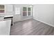Bright dining area featuring vinyl plank flooring, a stainless steel dishwasher, and a door to the backyard at 5612 Tealbrook Dr, Raleigh, NC 27610