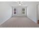 Empty bedroom with two windows, neutral carpet, a ceiling fan, and a bright, airy feel at 5612 Tealbrook Dr, Raleigh, NC 27610