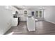 Modern kitchen with white cabinets, stainless steel appliances, and a center island with breakfast bar at 5612 Tealbrook Dr, Raleigh, NC 27610