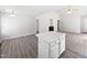 Spacious living area featuring wood flooring, fireplace, and a clear view of the island countertop at 5612 Tealbrook Dr, Raleigh, NC 27610