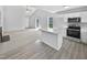 Bright living room featuring vaulted ceilings, an island, and an open layout to the kitchen at 5612 Tealbrook Dr, Raleigh, NC 27610