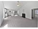 A spacious living area with vaulted ceilings, a cozy fireplace, and modern neutral carpeting at 5612 Tealbrook Dr, Raleigh, NC 27610