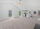 Open concept living room with kitchen, vaulted ceilings and carpet and wood flooring throughout at 5612 Tealbrook Dr, Raleigh, NC 27610