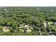 An aerial view displays a neighborhood nestled in a dense forest with well-maintained homes at 612 Harvest Ln, Raleigh, NC 27606