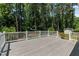 A spacious back deck offers a great outdoor space surrounded by lush trees at 612 Harvest Ln, Raleigh, NC 27606