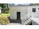 The back exterior of the house features a stair leading to an entrance door at 612 Harvest Ln, Raleigh, NC 27606