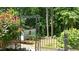 Back yard with a small shed, surrounded by trees and plants at 612 Harvest Ln, Raleigh, NC 27606