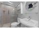 Ensuite bathroom with glass shower, toilet, sink, and modern decor at 612 Harvest Ln, Raleigh, NC 27606