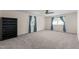 Large carpeted bedroom with a ceiling fan, natural light, and plenty of closet space at 612 Harvest Ln, Raleigh, NC 27606