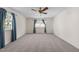 Spacious bedroom features plush carpet, ceiling fan, and natural light from two windows at 612 Harvest Ln, Raleigh, NC 27606