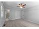 Bedroom with ensuite bathroom features carpet, ceiling fan, and closet at 612 Harvest Ln, Raleigh, NC 27606
