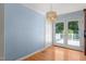 Open dining room includes hardwood floors, chandelier, and access to outdoor patio at 612 Harvest Ln, Raleigh, NC 27606