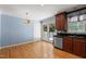 Eat-in kitchen features cherry wood cabinets, granite countertops, and access to outdoor patio at 612 Harvest Ln, Raleigh, NC 27606