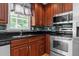 Cherry wood cabinets, granite counters, and stainless steel appliances in this eat-in kitchen at 612 Harvest Ln, Raleigh, NC 27606