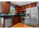 Updated kitchen features stainless appliances, granite counters, and wood cabinetry at 612 Harvest Ln, Raleigh, NC 27606