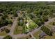 Overhead view of a home nestled among mature trees, marked with property lines in a green neighborhood at 6225 Jones Farm Rd, Wake Forest, NC 27587