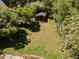 Aerial view of a lush backyard with mature trees and a charming shed at 6225 Jones Farm Rd, Wake Forest, NC 27587
