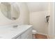 Well-lit bathroom with a round mirror over a white vanity, toilet, and a tub/shower combo at 6225 Jones Farm Rd, Wake Forest, NC 27587