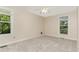 Inviting bedroom featuring plush carpet, large windows providing natural light and serene views, ideal for relaxation at 6225 Jones Farm Rd, Wake Forest, NC 27587
