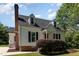 Charming two-story home featuring black shutters, brick details and a well-manicured front yard at 6225 Jones Farm Rd, Wake Forest, NC 27587