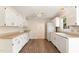 Functional kitchen featuring white cabinets, laminate floors, and a complete appliance set, offering efficient meal preparation at 6225 Jones Farm Rd, Wake Forest, NC 27587