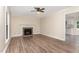 A living room featuring a brick fireplace, ceiling fan, and light-colored walls at 6225 Jones Farm Rd, Wake Forest, NC 27587